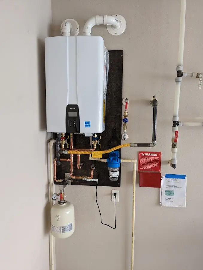 Professional plumber installing copper piping in a Pine Hills home